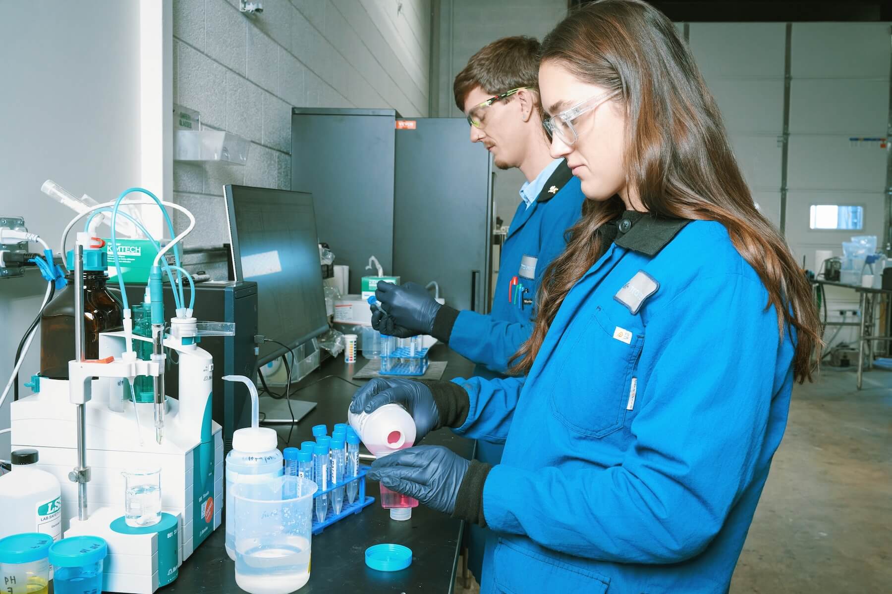 Two employees working on process