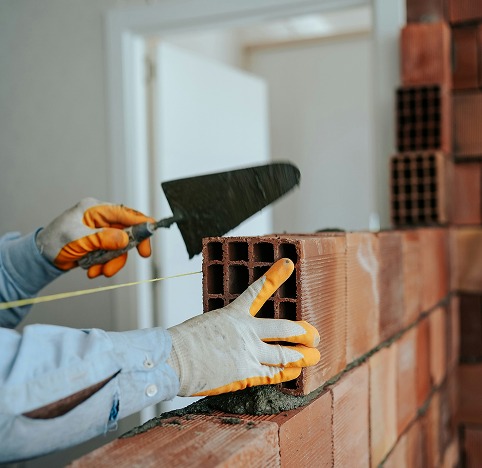 A person engaged in bricklaying